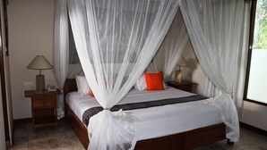 A bedroom with a bed, two bedside tables, a lamp on each table, and a window with curtains. - Nefatari Exclusive Villas (Ubud)