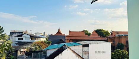 A view of buildings with various roof styles and a clear sky.