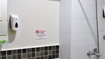 A bathroom with a sink, toilet, and shower.