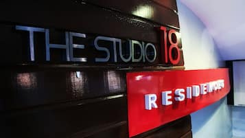 A sign with "THE STUDIO 18" and "RESIDENTS" indicating a residential area or building.