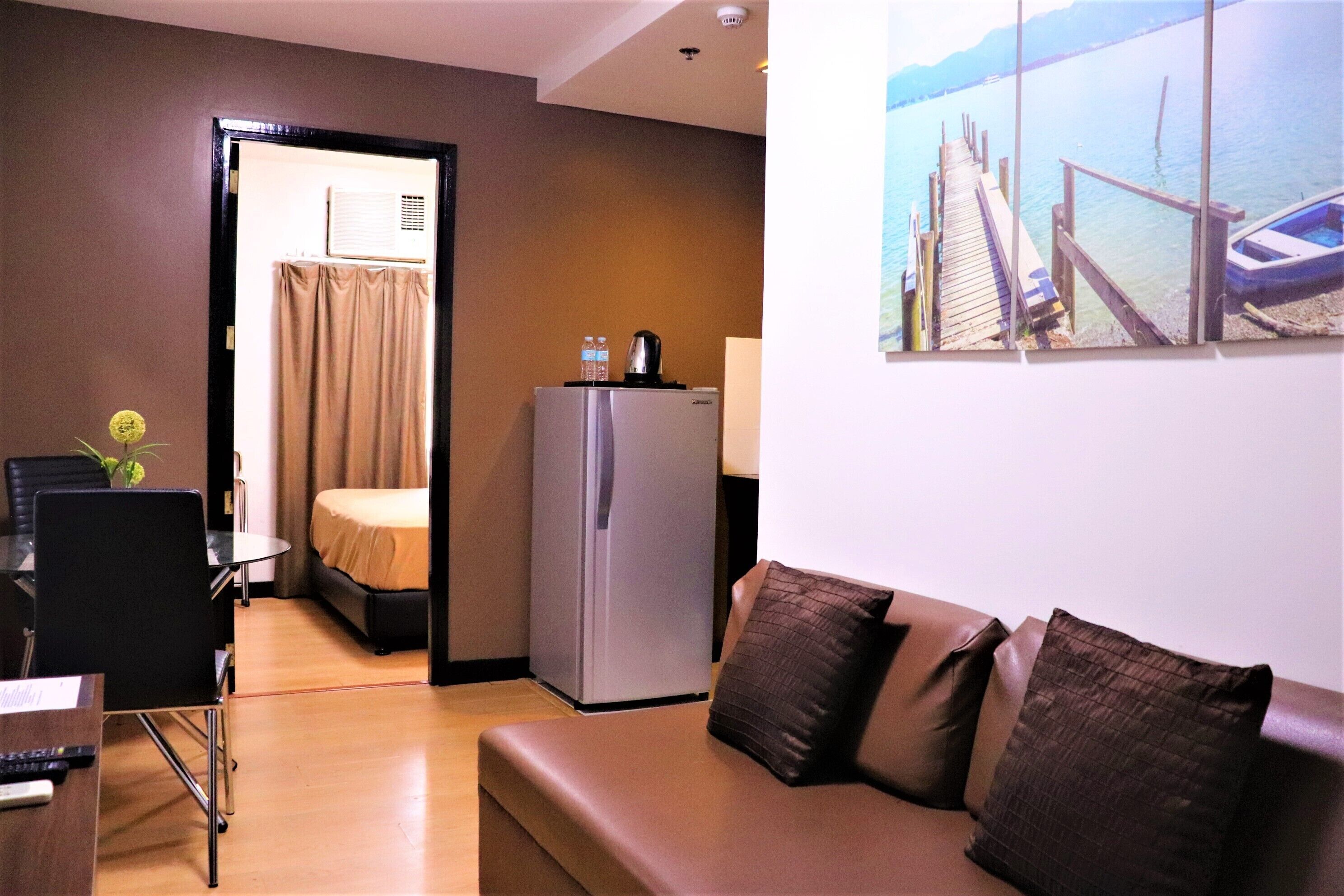 Junior Suite, 1 Bedroom | Living room | 24-inch LED TV with cable channels, TV