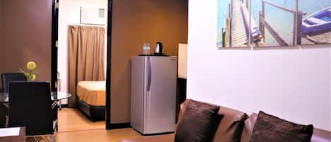 Junior Suite, 1 Bedroom | Living room | 24-inch LED TV with cable channels, TV