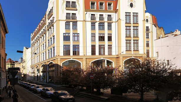 A multi-story building with a distinct architectural style, featuring balconies and large windows.