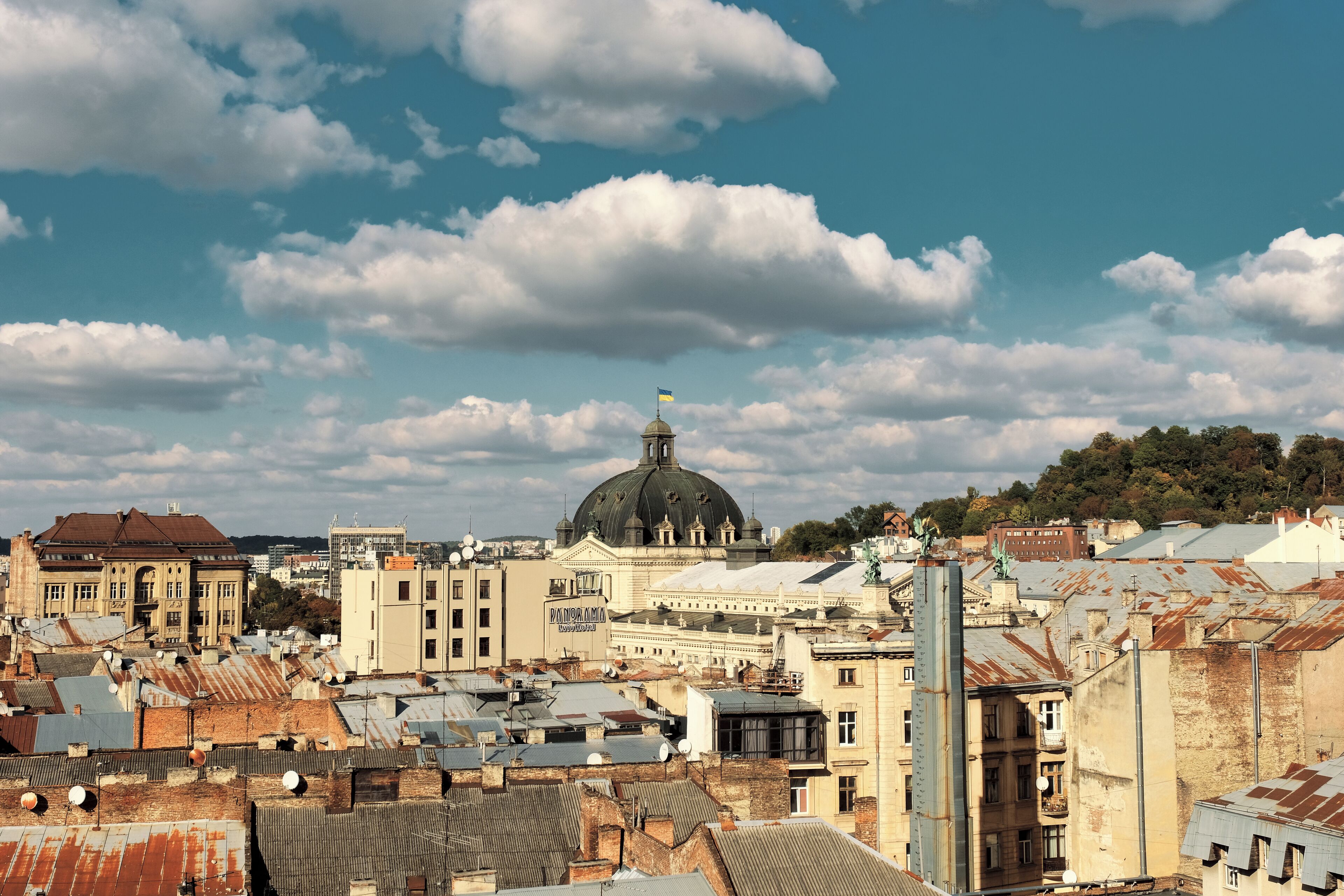A cityscape with historic buildings, a prominent dome structure, and a mix of architectural styles.
