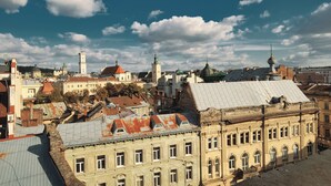 A historic building with multiple windows and a prominent dome structure.