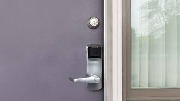 A door with a keyhole and a modern door handle.