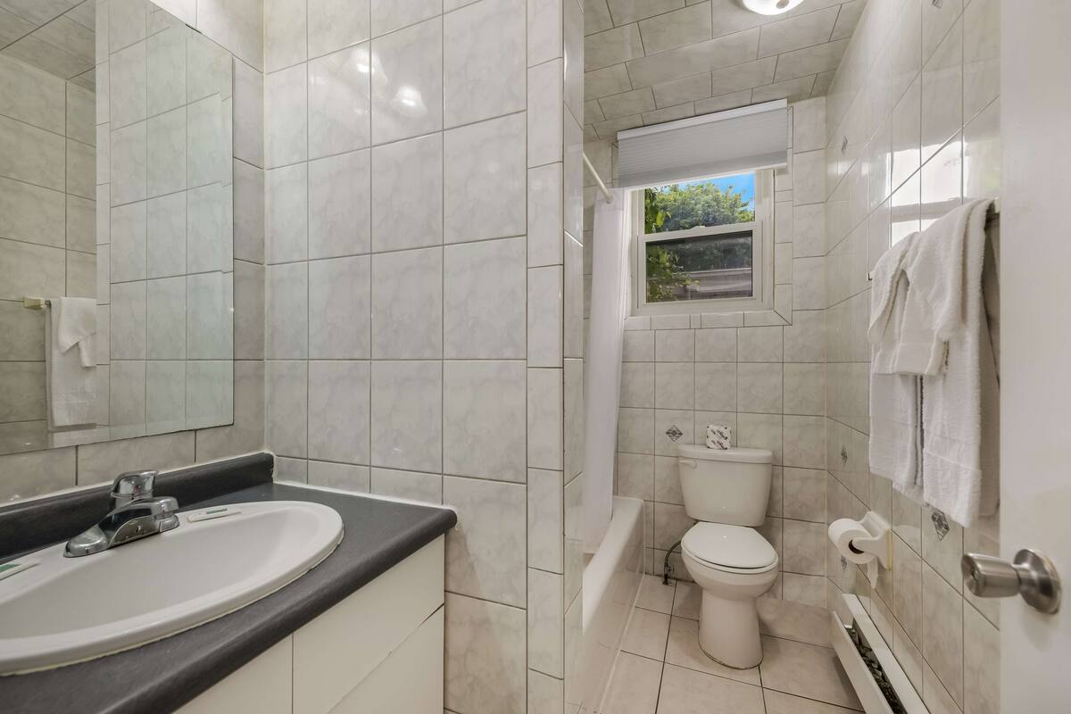 A bathroom with a sink, toilet, and bathtub.