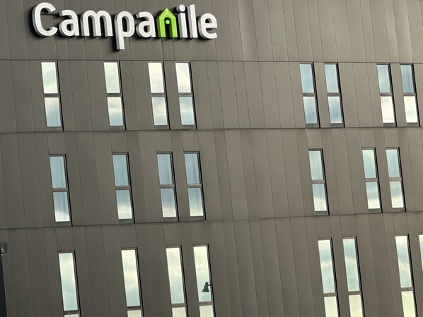 A building facade with a sign reading 'Campanile' and multiple windows.