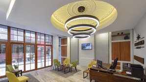 A modern office space with large windows, a wooden desk, and multiple chairs. - Sayeban Gold Hotel (Istanbul)