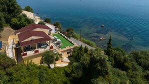 A coastal property with a patio, a swimming pool, and a view of the sea. - Batelo Boutique Hotel - Adults Only (Corfu)