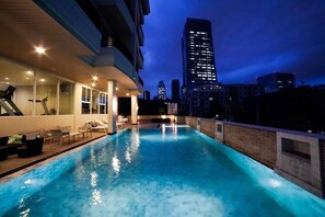 A swimming pool with a cityscape view, a fitness area, and a lounge with outdoor seating. - Bangkok Patio (Bangkok)