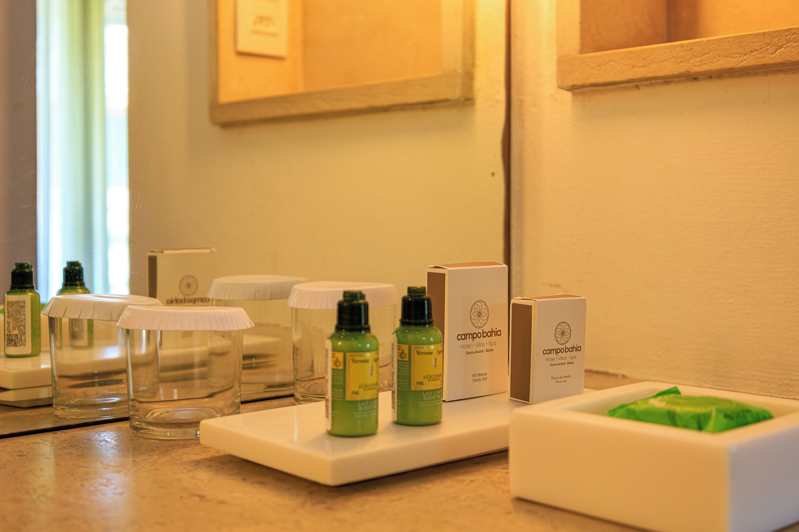 A hotel reception area with a counter displaying toiletries and a green package.