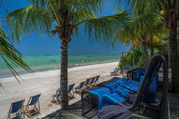 On the beach, white sand, sun loungers, beach umbrellas