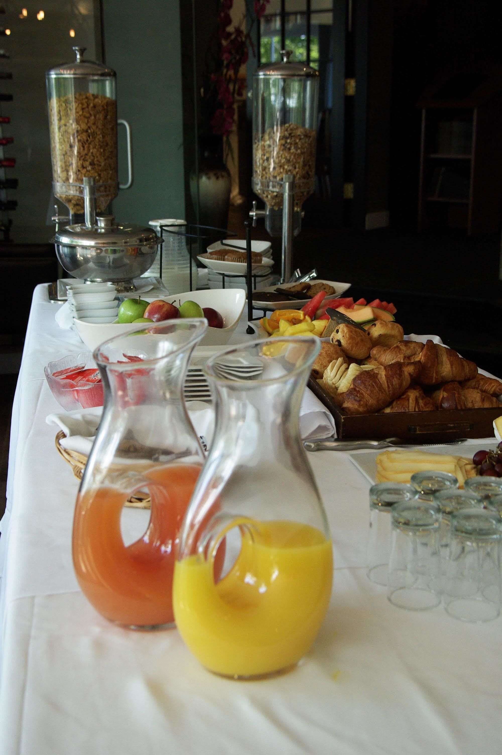 A breakfast buffet with various food items and beverages.