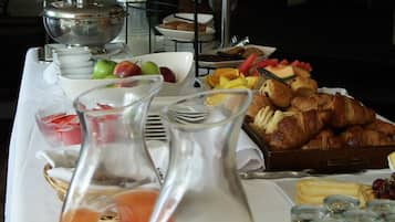 En morgenmadsbuffet med et udvalg af mad og drikkevarer.