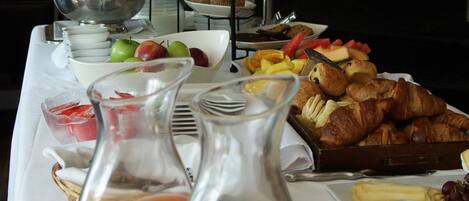 A breakfast buffet with various food items and beverages.