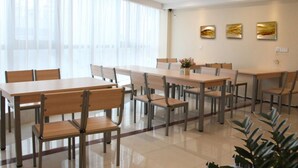 A modern dining area with large windows, multiple tables, and chairs. - GreenTree Inn Yulin Jincheng Commercial Building Shell Hotel (Yulin)