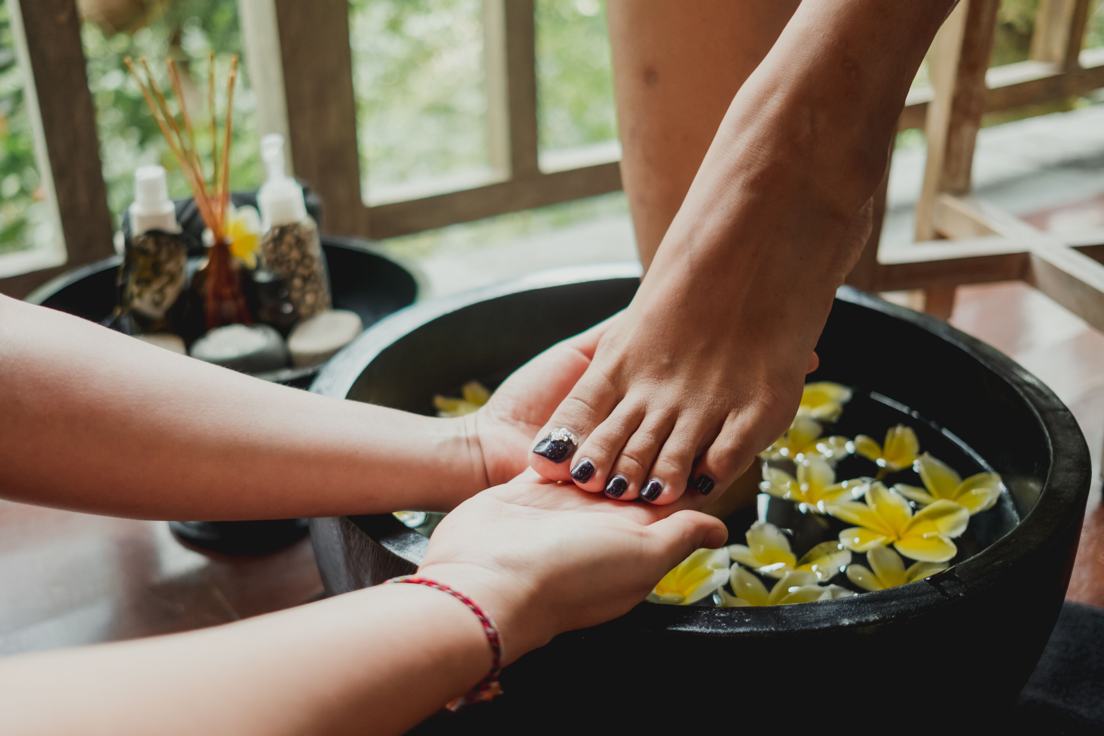 A foot soak with flowers and essential oils.