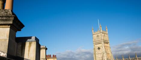 A historic building with a prominent clock tower, featuring intricate stonework and multiple spires.
