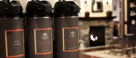 Three insulated water bottles with labels on a countertop.