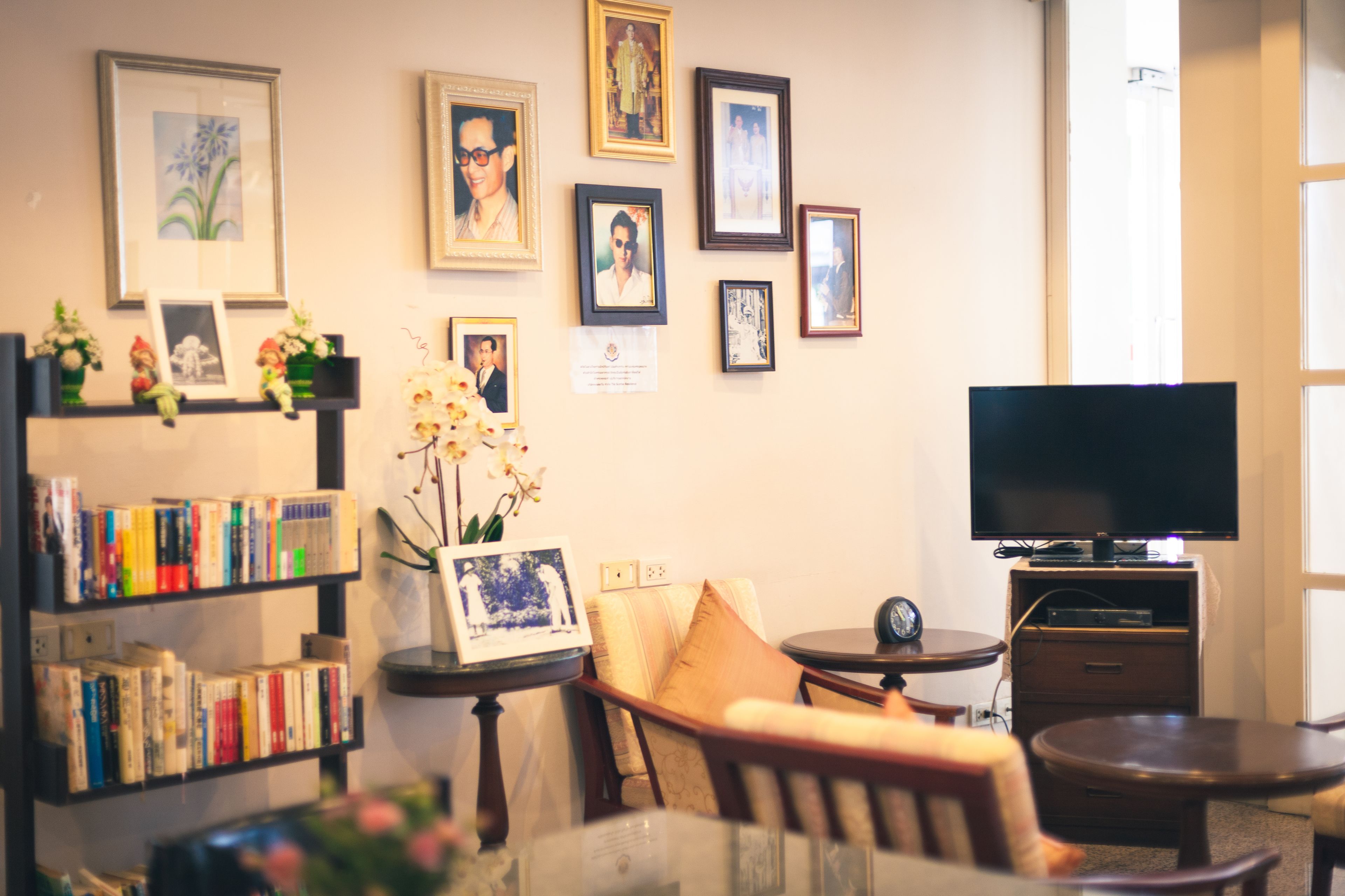 A living room with a bookshelf, a TV, a sofa, and a coffee table.