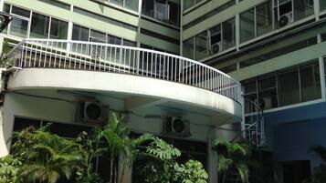 A multi-story building with a pool area.