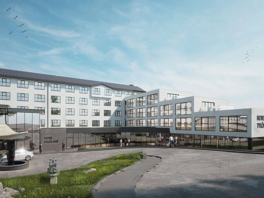A modern hotel with a central glass facade, multiple floors, and a parking area.