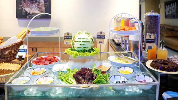 A buffet with various food options including salad bar, baguette, and ice cream. - Atrium Premiere Hotel (Yogyakarta)