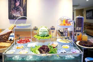 A buffet with various food options including salad bar, baguette, and ice cream. - Atrium Premiere Hotel (Yogyakarta)