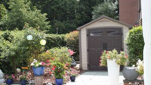A garden with potted plants and a shed.
