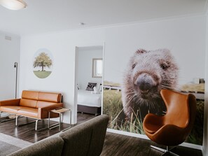 Deluxe Two Bedroom Apartment | Living area | 50-inch Smart TV with premium channels, TV, tablet