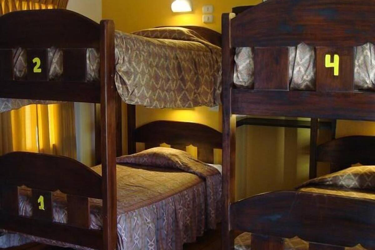A room with four bunk beds, each marked with a number from 1 to 4.