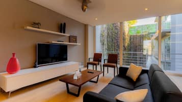 Junior Suite, Balcony | Living area | 39-inch flat-screen TV with cable channels, TV
