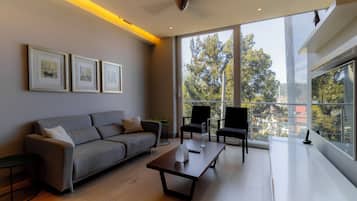 Deluxe Suite, Balcony | Living area | 39-inch flat-screen TV with cable channels, TV