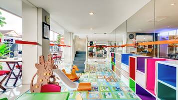 A children's play area with colorful furniture and a play mat.