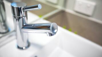 A modern bathroom sink with a chrome faucet.
