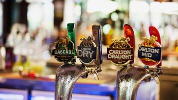 A bar with taps labeled Cascade Premium Light, Carlton Dry, Carlton Draught, and Carlton Mid.