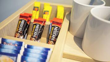 A tray with Nescafé Blend 43 coffee packets and a cup of coffee.