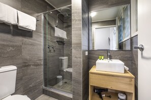 A modern bathroom with a glass-enclosed shower, a toilet, and a wooden vanity with a sink. - Nightcap at Sylvania Hotel (Campbellfield)