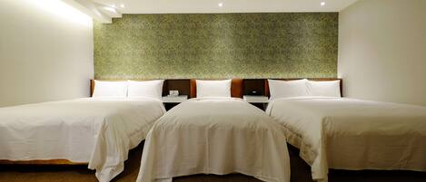 A hotel room with two single beds, a large wall mural, and a carpeted floor.