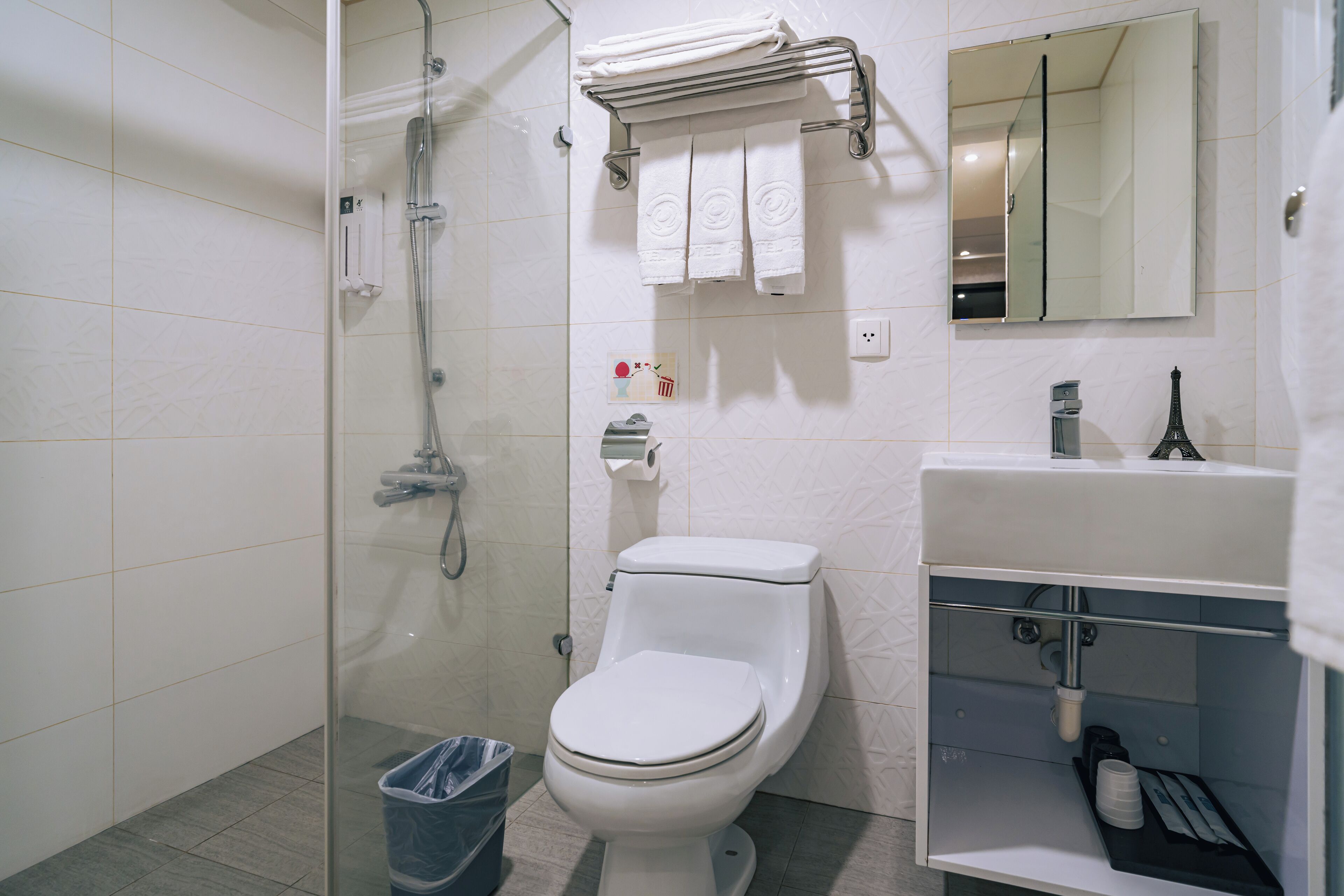 shower, hair dryer, towels, shampoo