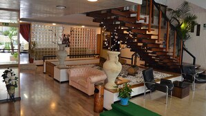 A modern interior with a staircase, seating area, and decorative elements. - Hotel Arena (Cattolica)