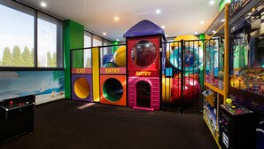 An indoor play area with colorful play structures, including a slide and climbing walls, and arcade games. - Nightcap at Gateway Hotel (Corio)