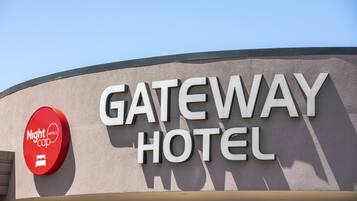 A sign for Gateway Hotel with a red circular logo for Nightcap Hotels.