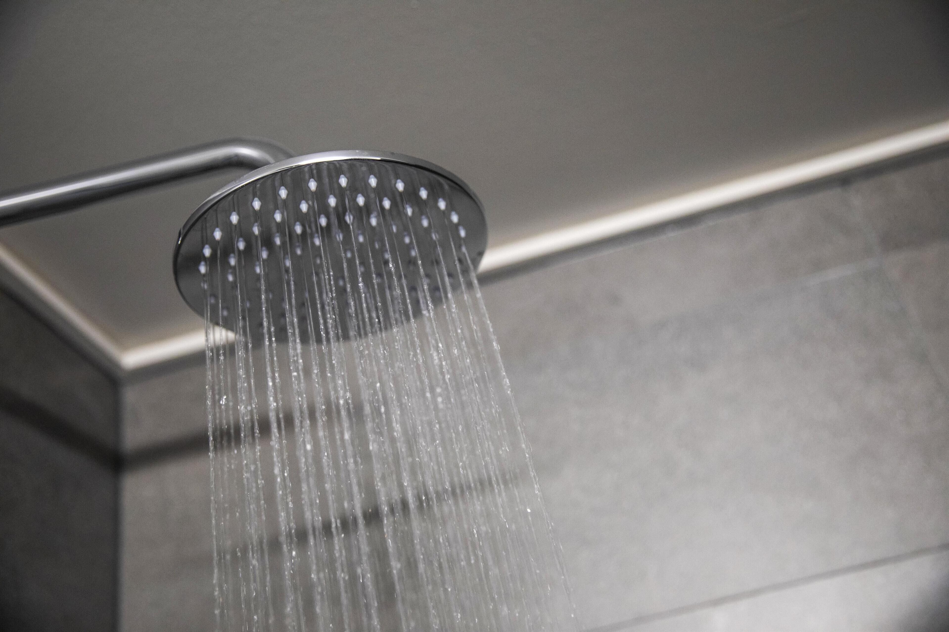 A showerhead with water flowing down.