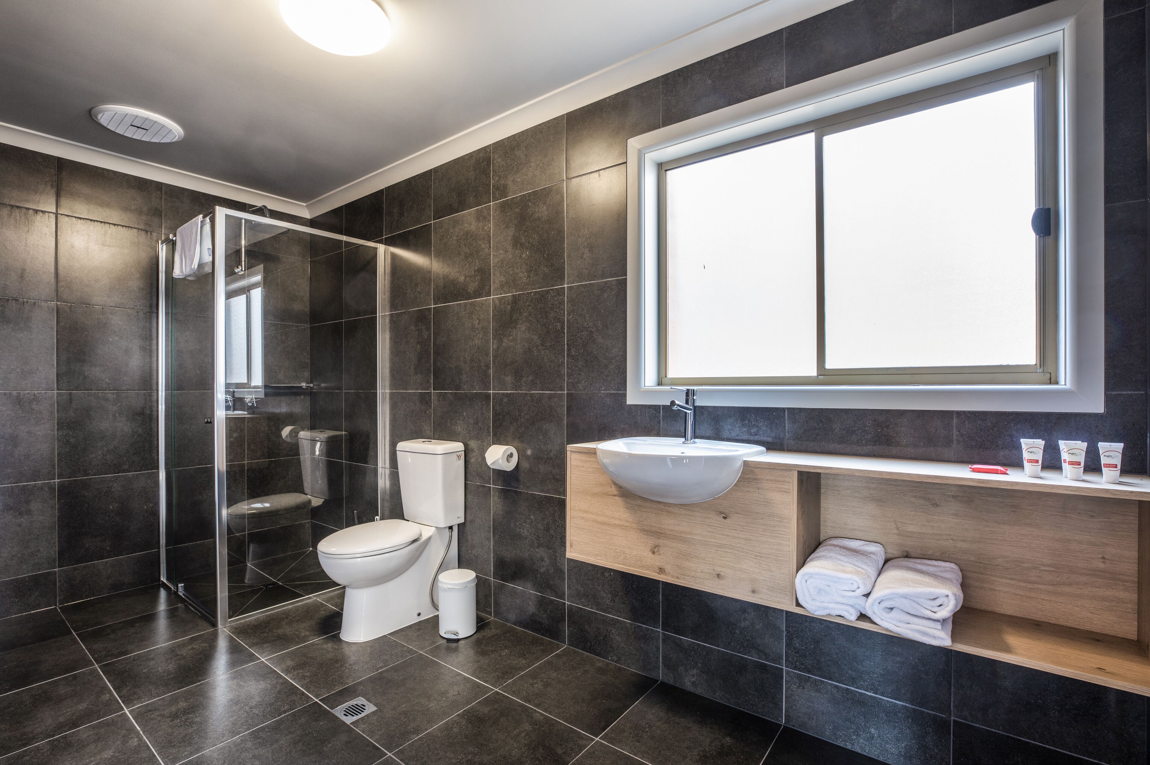 studio family | bathroom | shower, rainfall showerhead, hair dryer, towels