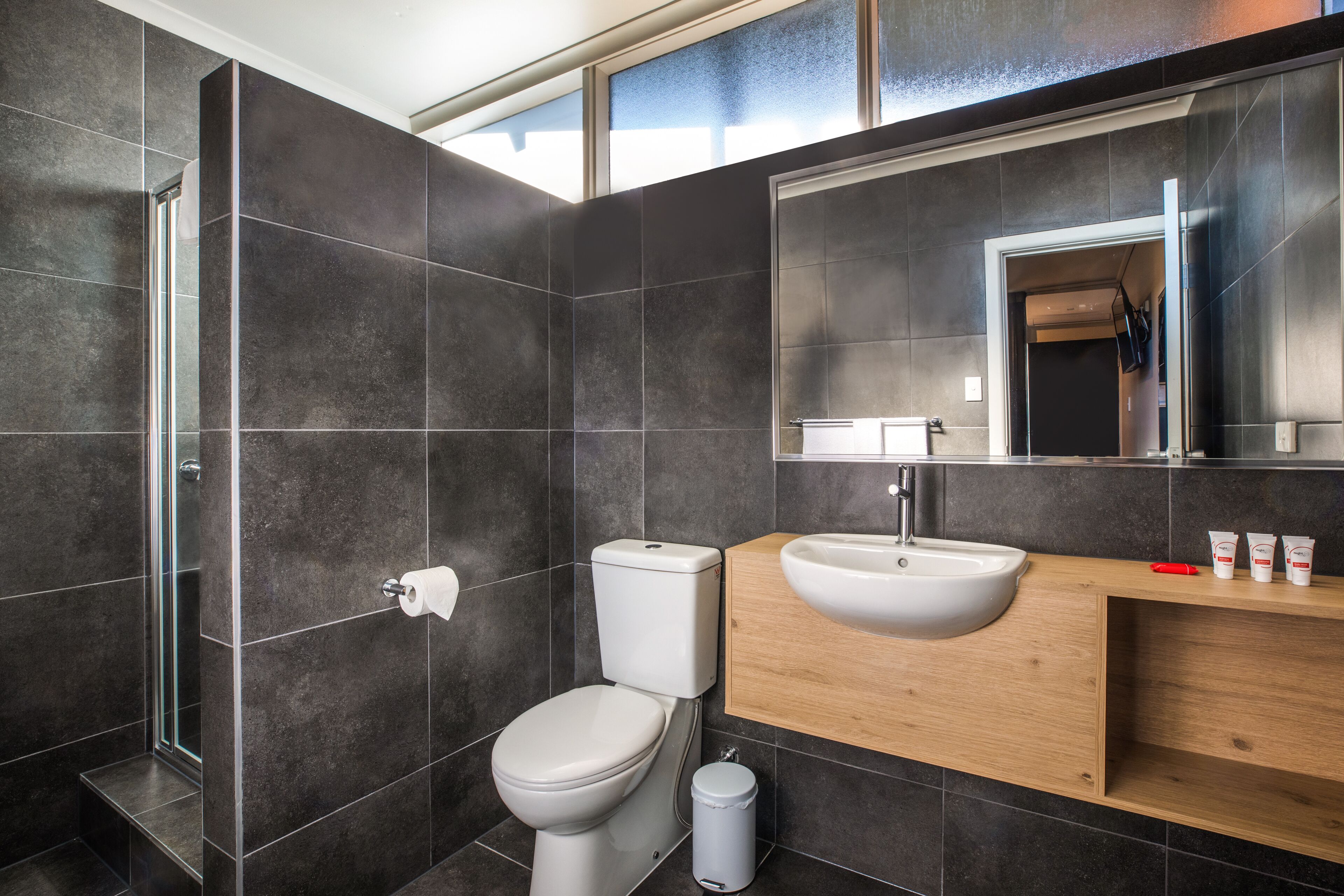 studio queen | bathroom | shower, rainfall showerhead, hair dryer, towels