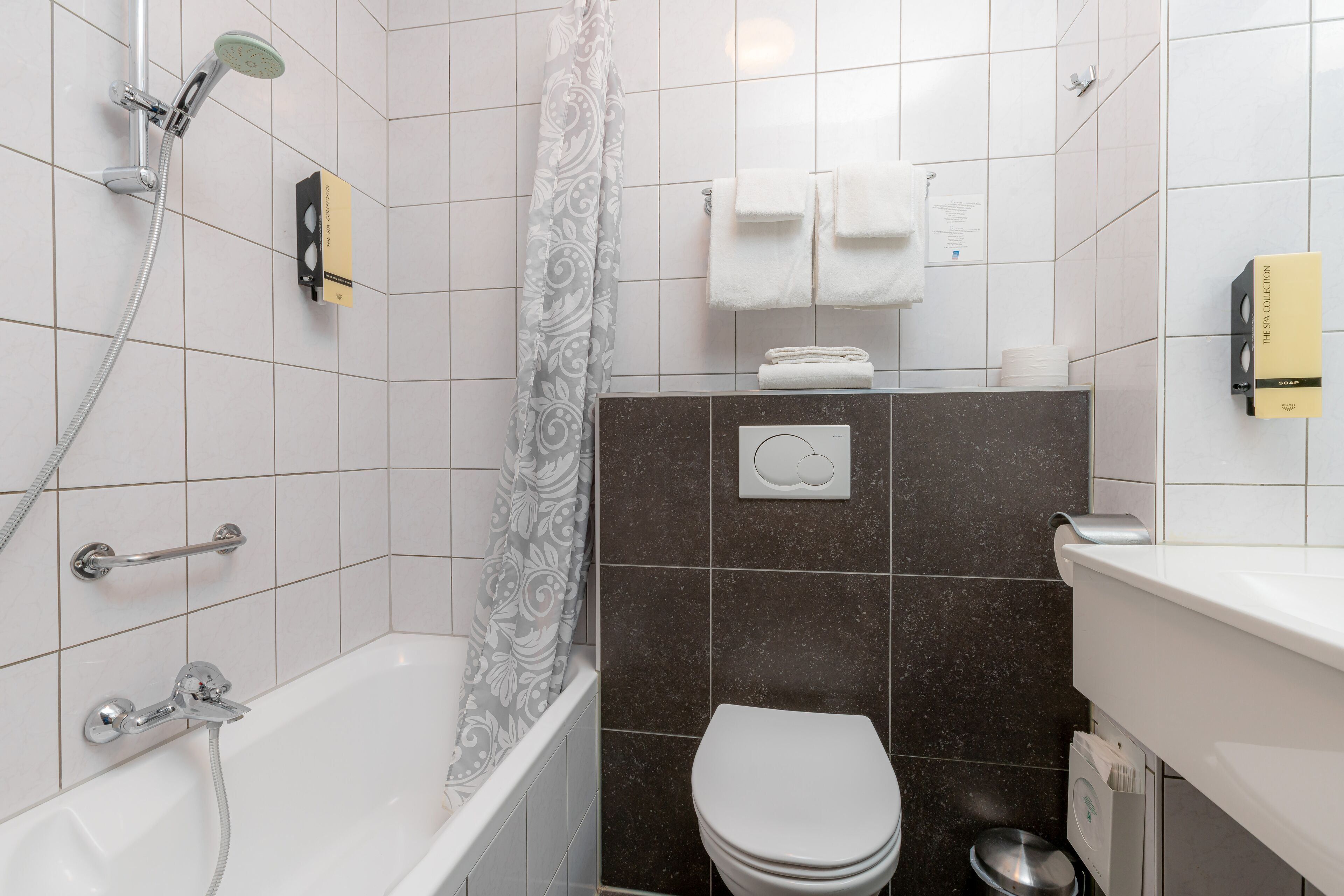 A bathroom with a bathtub, toilet, and shower.