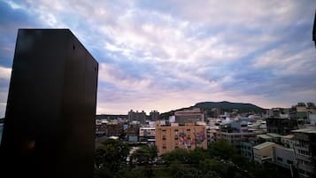 A cityscape with a variety of buildings, including a prominent modern structure on the left.