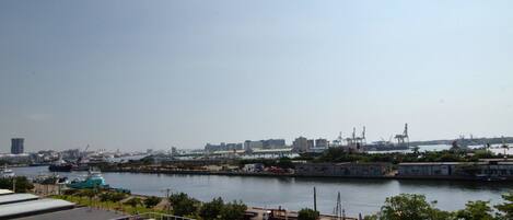 A harbor with ships, cranes, and industrial buildings.